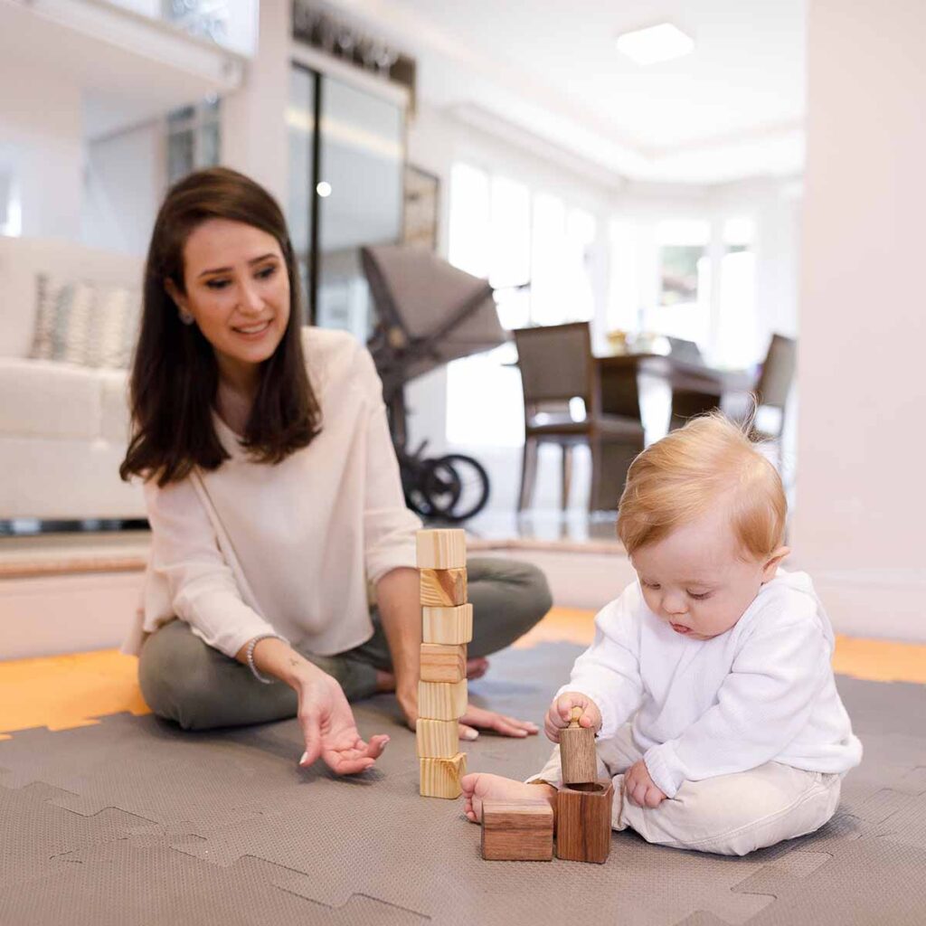 Female therapist works with preschooler using educational development toys