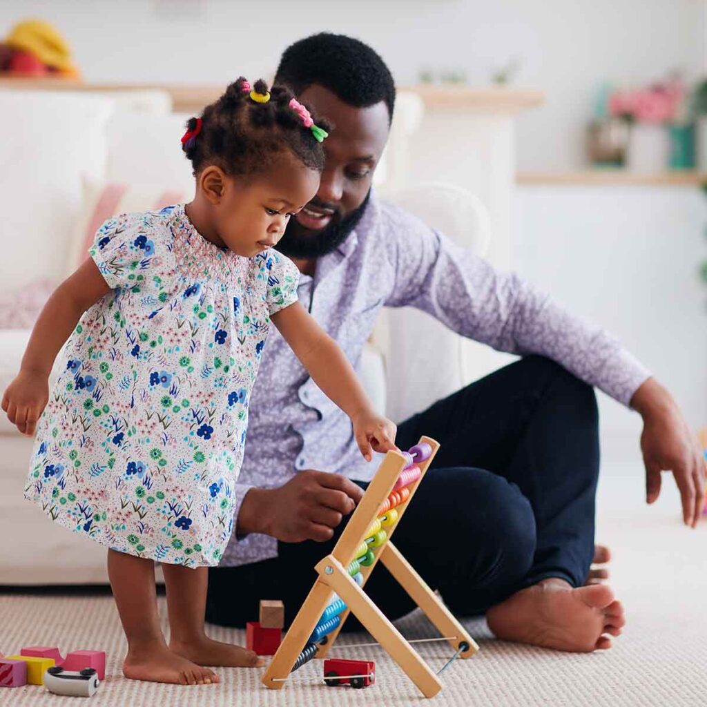 Male Therapist working with preschooler using educational development toys.